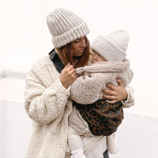 Child being carried in the Wildride Toddler Carrier in brown leopard