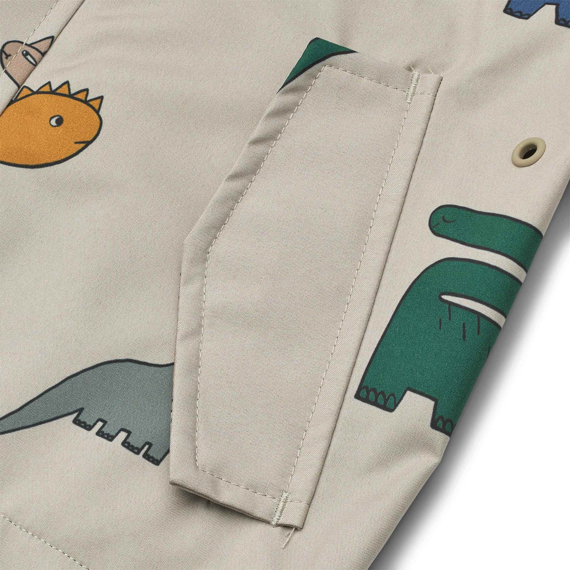 Liewood Manu Rain Jacket - Dinosaurs / Mist - close up on pocket