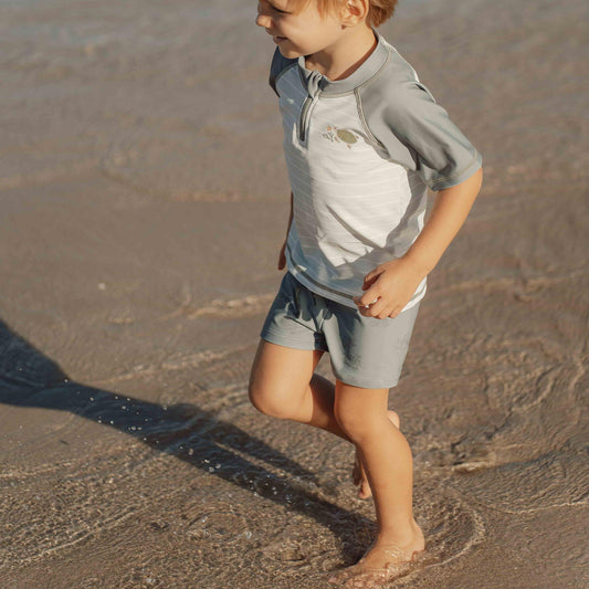 Little Boy Playing In The Sea Little Dutch Swimming Trunks - Turtle Island