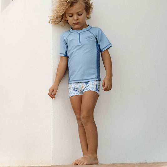 Little Boy Wearing The Little Dutch - Swimming Trunks Ocean Dreams Blue