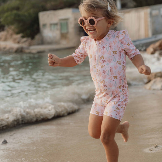 little girl wearing a little Dutch Short Sleeve Swimsuit in Ocean Dreams print in colour Pink