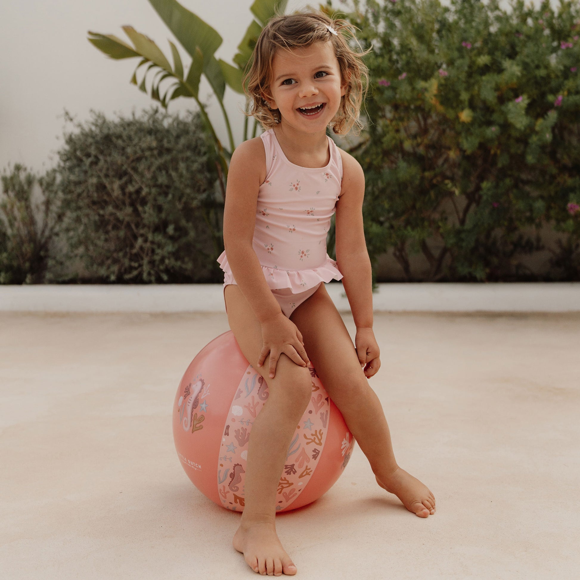 Little girl wearing the rosy Meadows swimsuit by little dutch