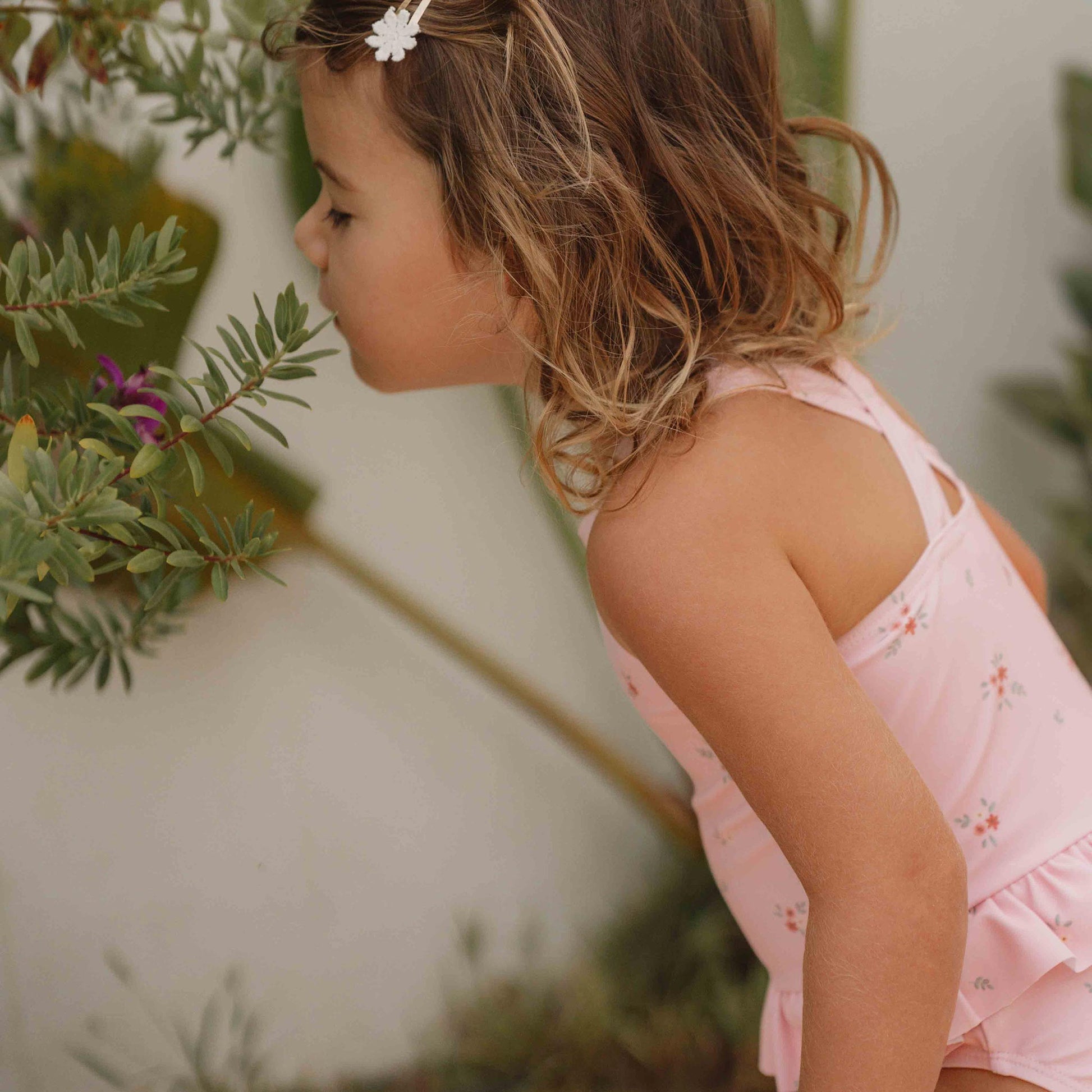 girl wearing the Little Dutch Rosy Meadows Swimming Costume