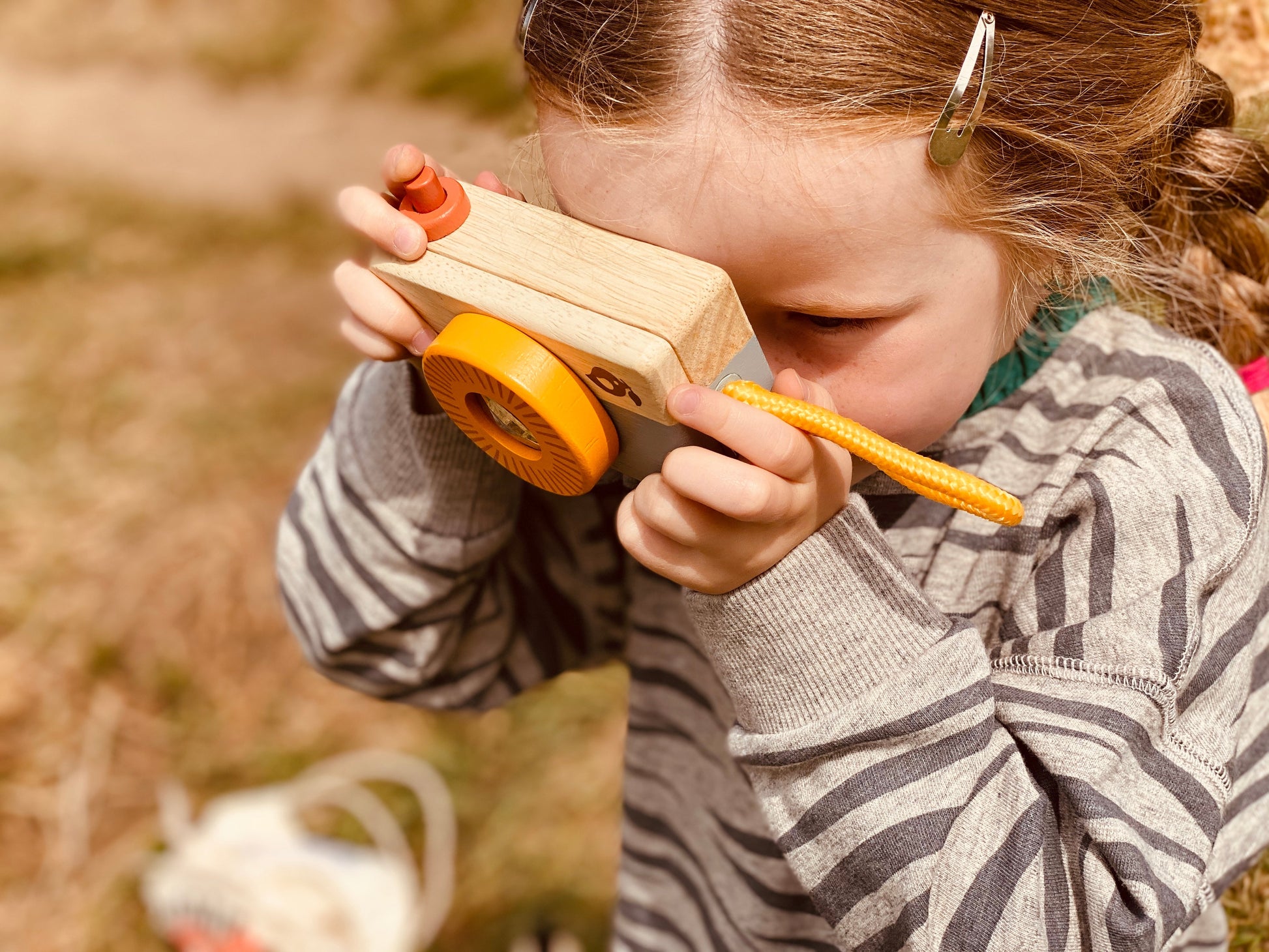 child with toy camera