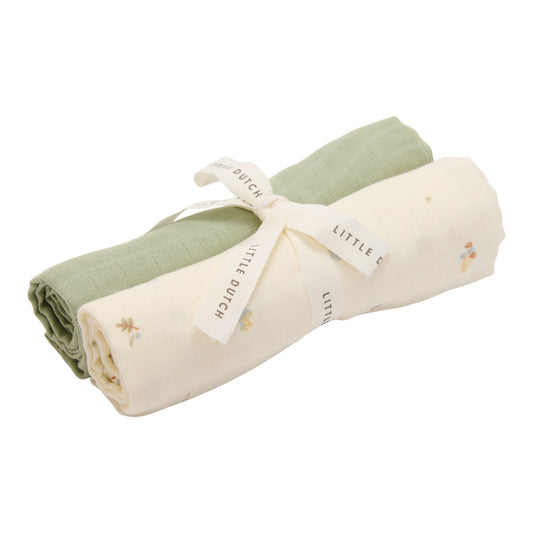 Two muslin cloths wrapped with a ribbon, one sage green and one a cream colour with various autumnal elements decorating it